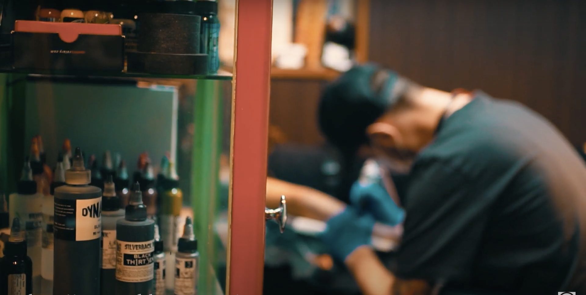 Magnus tattooing at Red Bunny Tattoo, ink bottles in the foreground