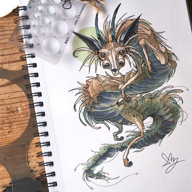 Hairy fox-like spirit creature drawn in a ring-bound sketchbook